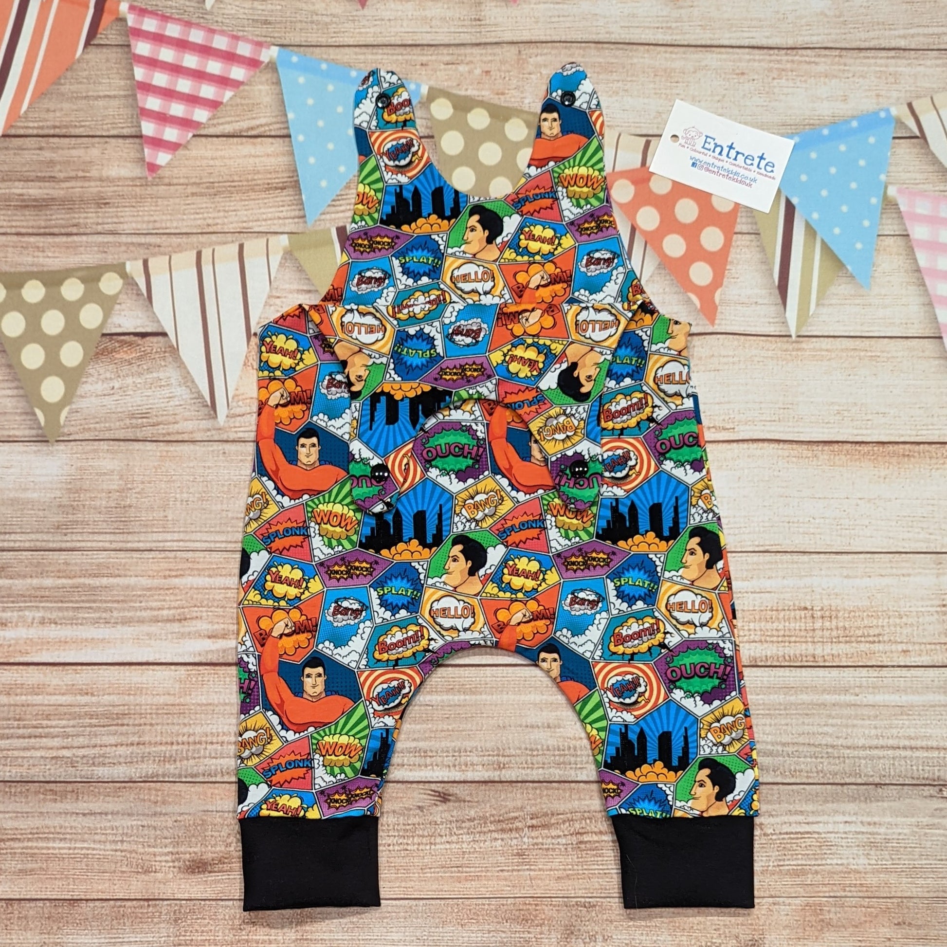 The awesome superhero sleeveless romper with it's comic strip print. Handmade using superhero and black cotton jerseys'. Shown with the shoulder popper entry open.