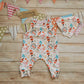 The beautiful white nutcracker romper, shown as a set with a matching bamboo bib. (sold separately)