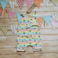 Unisex kids romper shorts, handmade using stunning rainbow stars cotton jersey. Shown with one of the shoulders open.