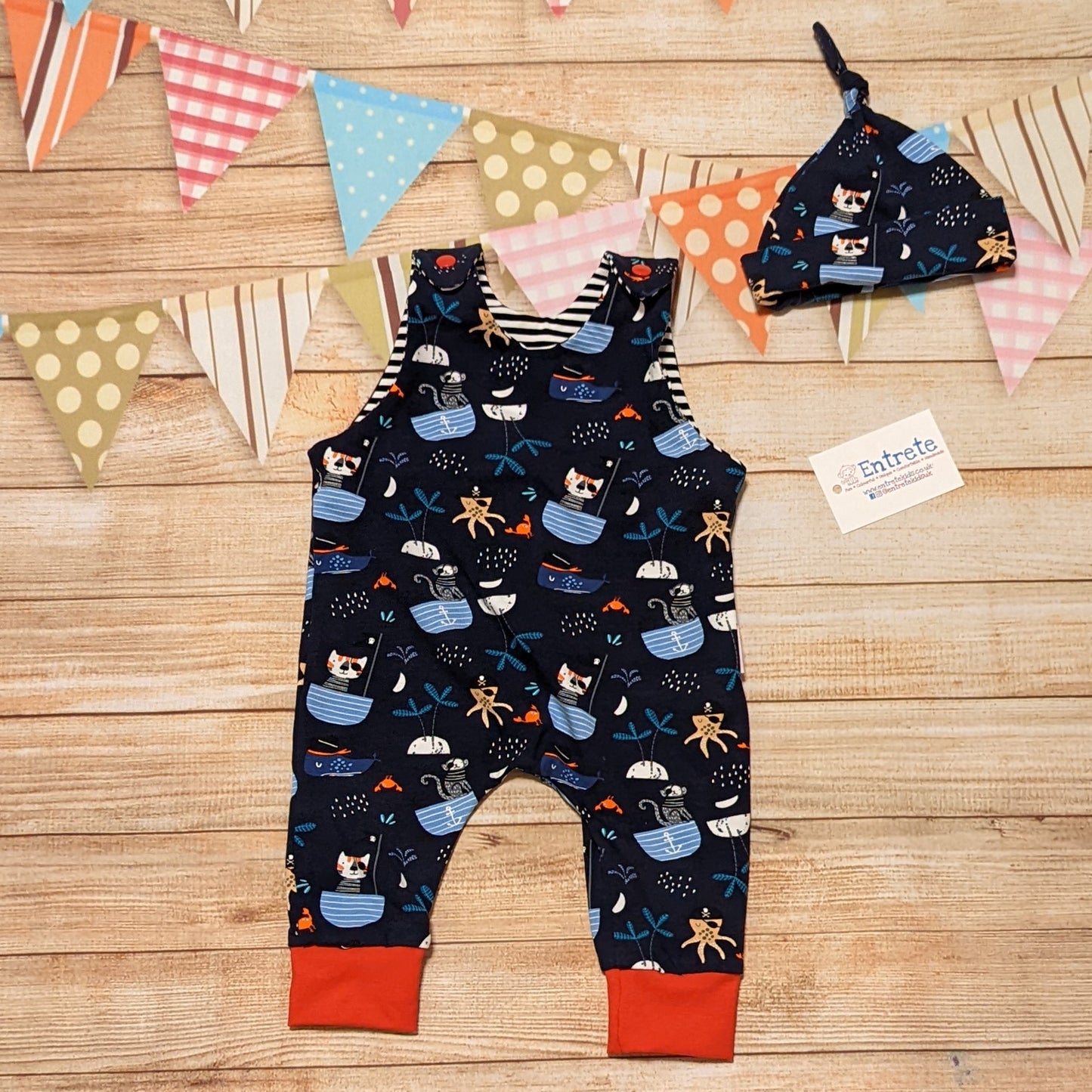 Fun and adventure await, with the pirate cats sleeveless romper. Shown with a matching tie top hat (sold separately). Handmade using pirate cats, red and monochrome striped cotton jersey's.