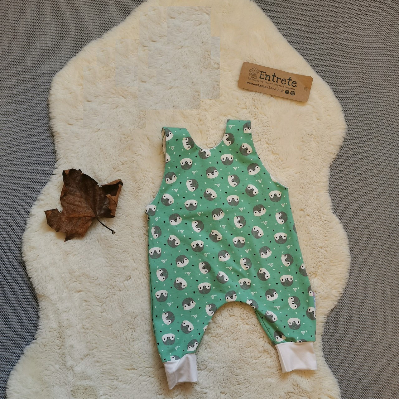 Rear view of the gorgeously ethical organic mint penguins sleeveless romper. Handmade using mint penguins and white organic cotton jerseys' with a natural bamboo lining.
