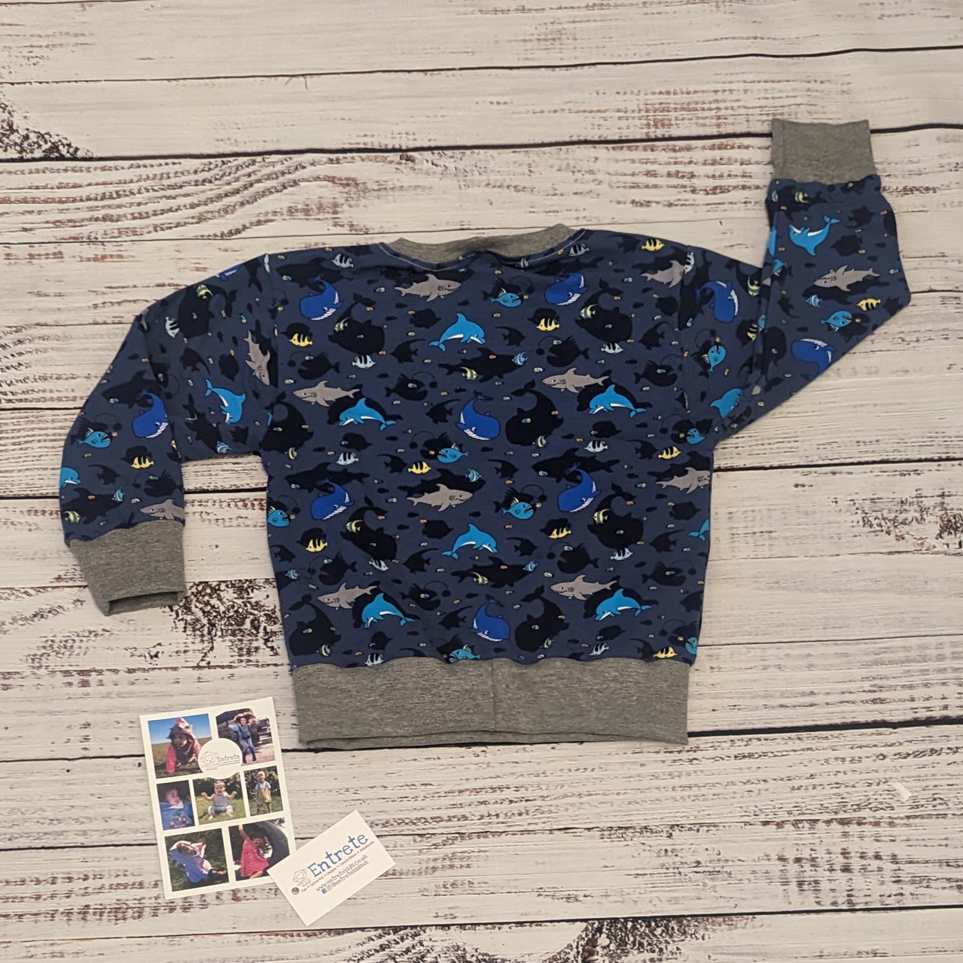 The amazing sea life sweatshirt, packed full of your favourite sea creatures. Handmade using navy sea life shadows cotton jersey and grey cotton ribbing. Shown from the rear.