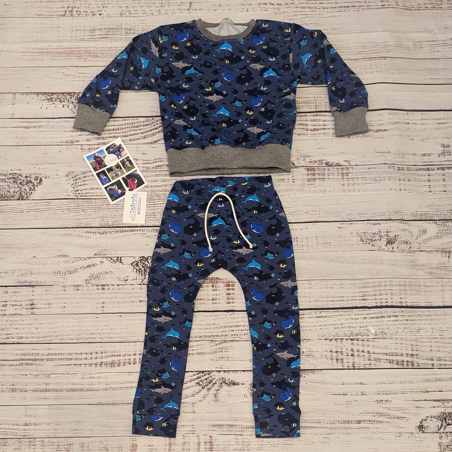Kids navy sea creatures harem joggers. Handmade using navy sea life shadows cotton jersey. Shown as an outfit with matching sweatshirt.