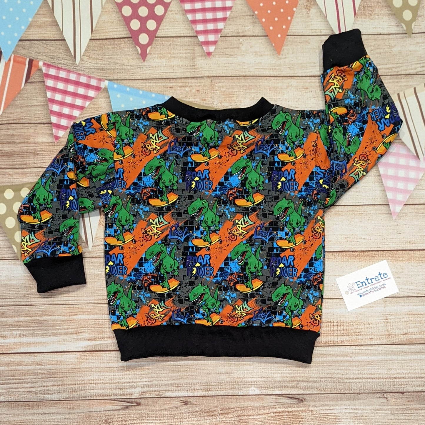The insanely fun skateboarding dinosaurs sweatshirt. Handmade using street dino cotton French terry and black cotton ribbing. Shown from the rear.
