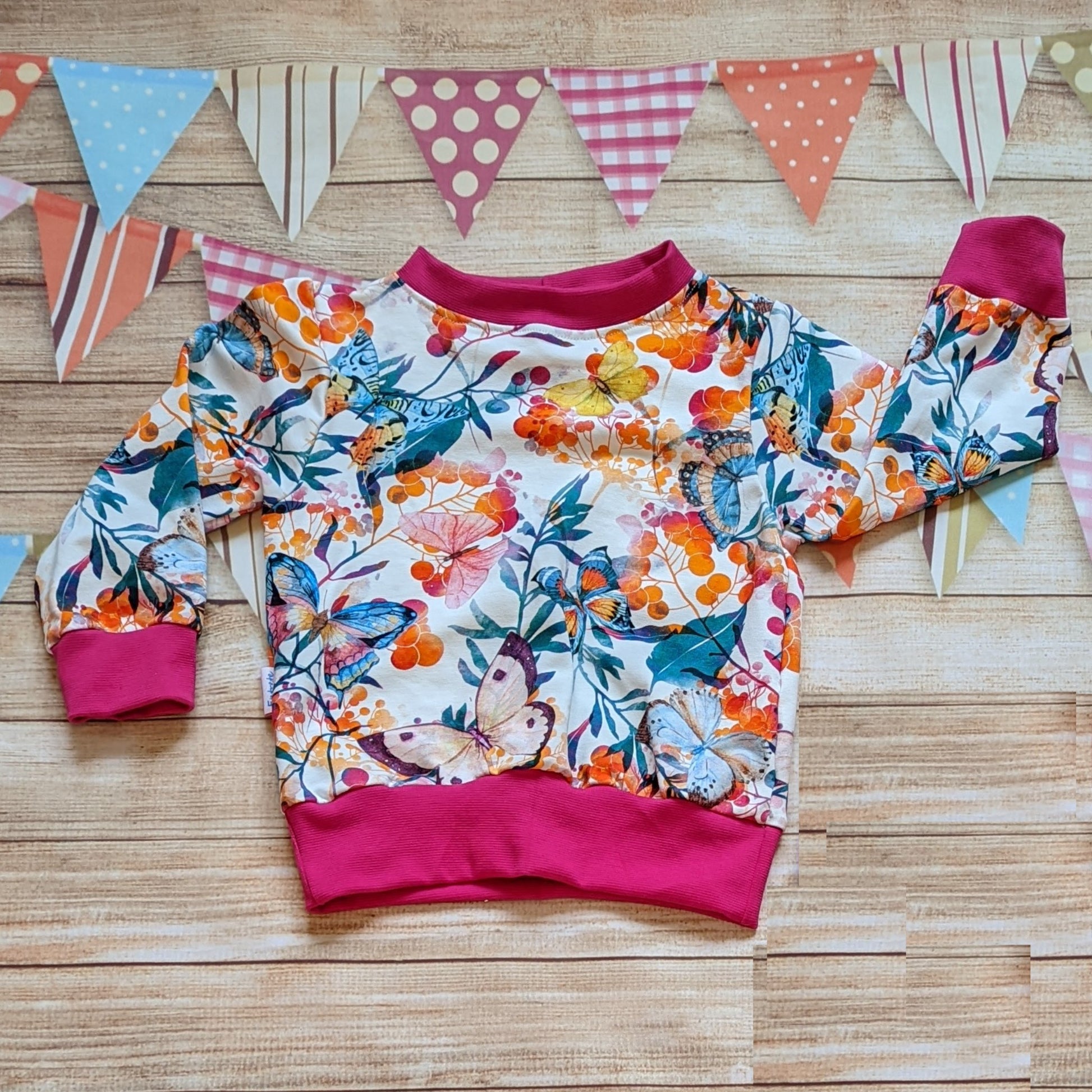 Long sleeve vibrant butterflies and flowers sweatshirt. Handmade using vibrant butterflies cotton jersey and fuchsia cotton ribbing.