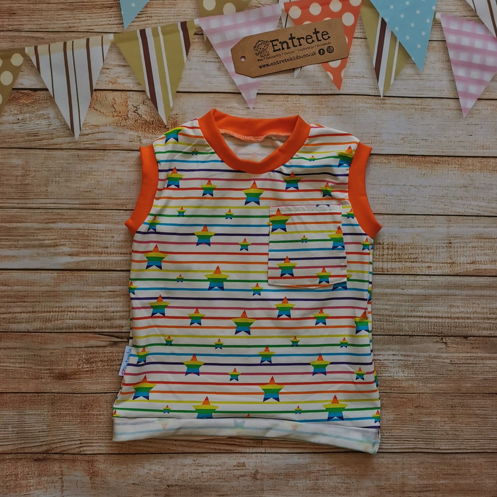 Child & Babies tank top, handmade using colourful rainbow stars cotton jersey and orange cotton ribbing. Featuring a front pocket and rolled waist.