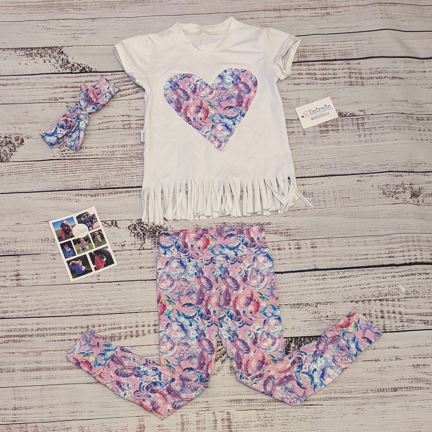 The bubblegum pink bubbles leggings shown as an outfit with matching pink bubble heart tassel tee and headband.