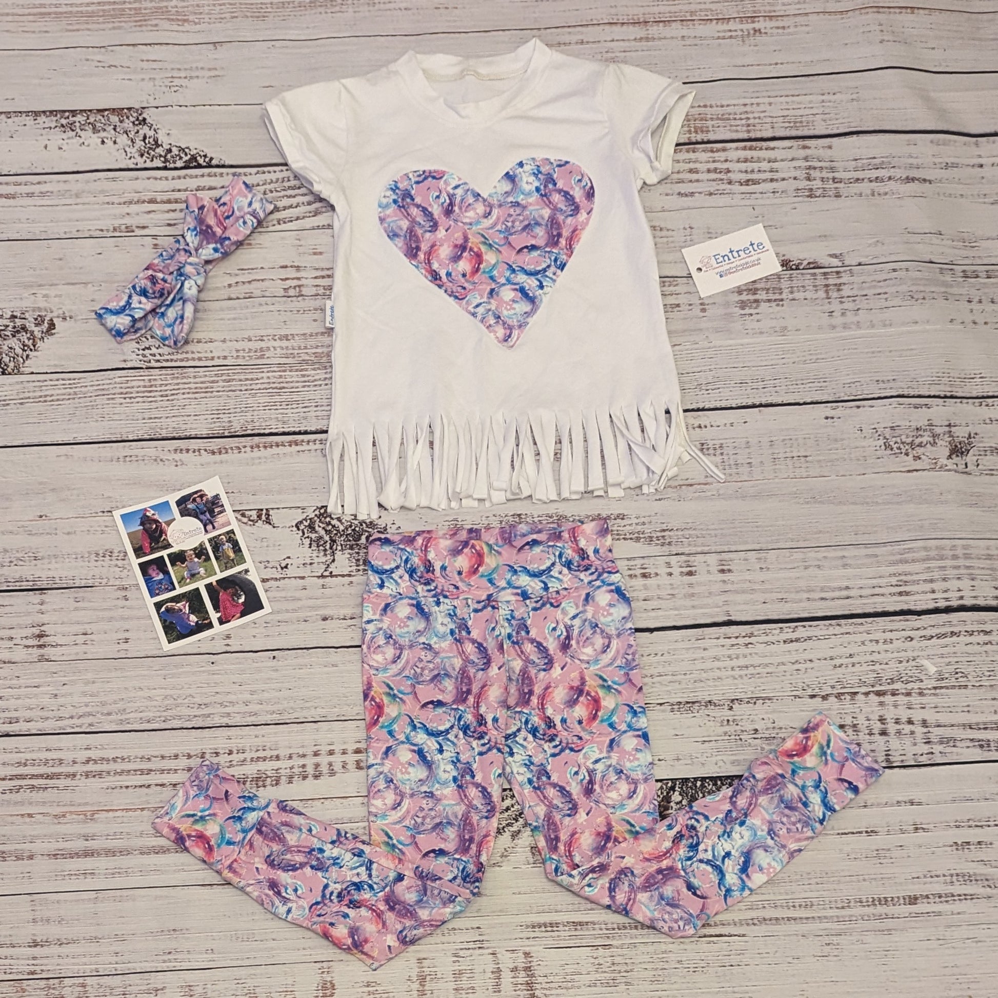 Bubblegum pink bubbles heart tassel tea. Shown with matching leggings.