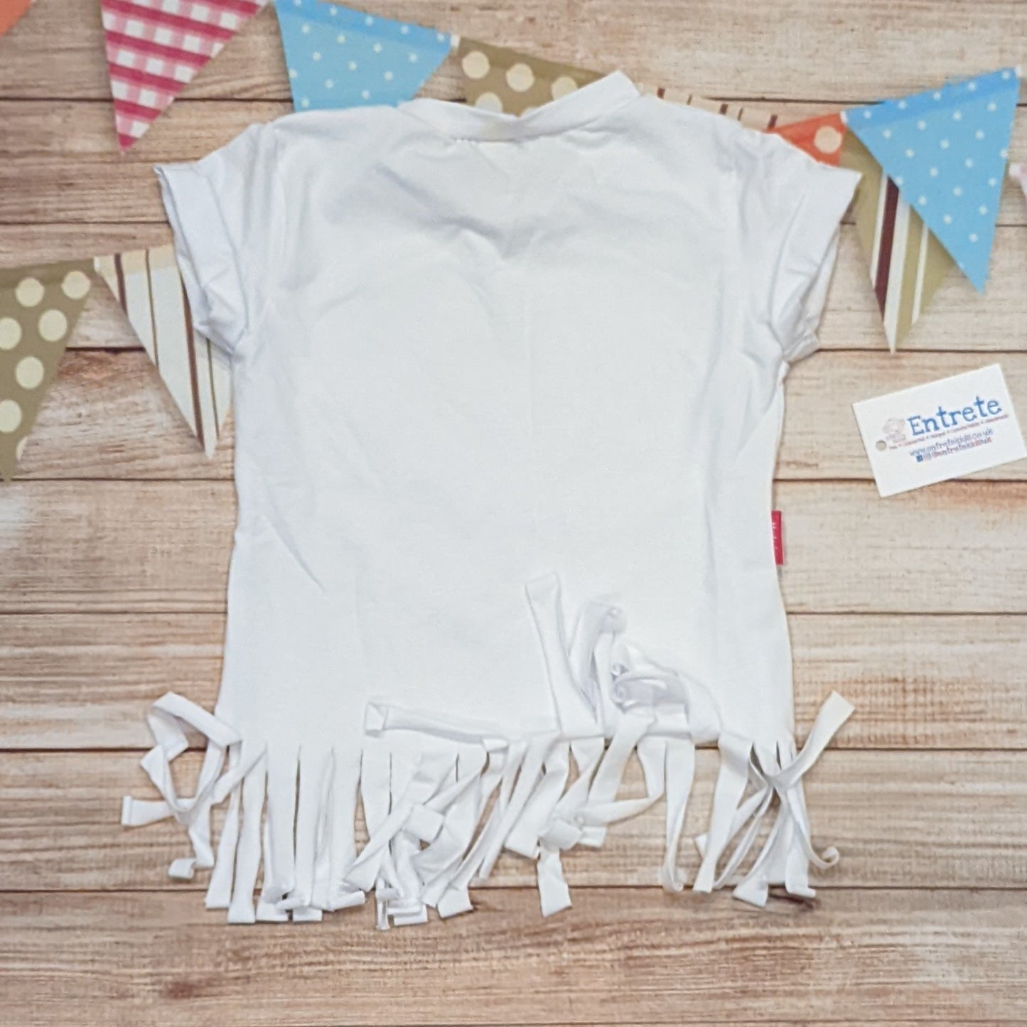 The feminine and beautiful mini rainbows heart tassel tee. Handmade using white and mini rainbows on white cotton jersey's, with white cotton ribbing. Shown from the rear.
