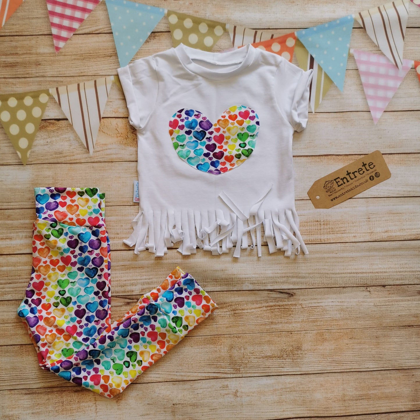 Watercolour rainbow hearts tassel tee shown as an outfit with some rainbow hearts leggings. (sold separately)