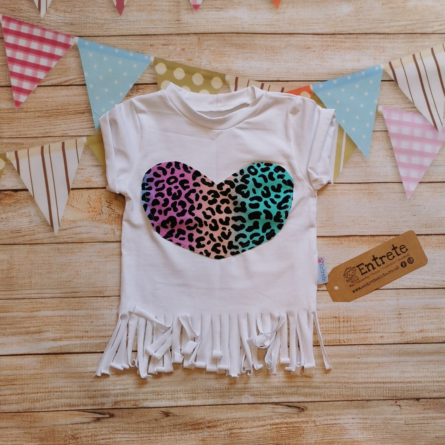 Feminine girls tassel tee, handmade using white cotton jersey, rainbow leopard print cotton jersey heart detailing and cream ribbing. With rolled cuffs and tassels on the waist.