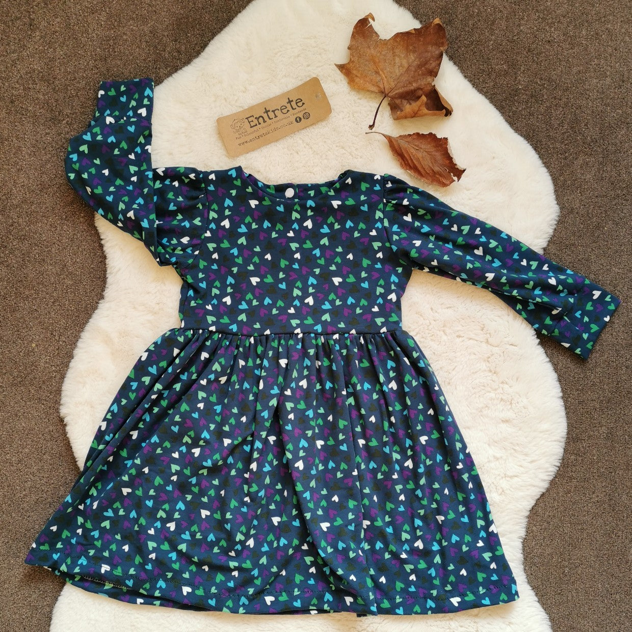 Girls & Babies back popper dress. Handmade in teal hearts cotton jersey. Shown with long sleeves.
