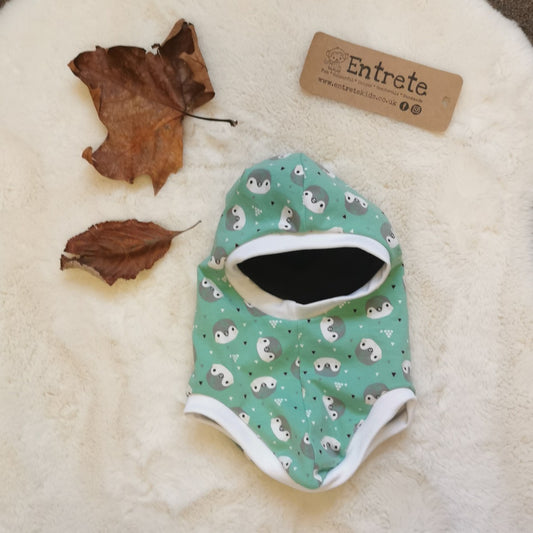 Soft and stretchy kids organic balaclava handmade using mint penguins organic cotton jersey, white organic cotton ribbing and black organic cotton jersey lining.