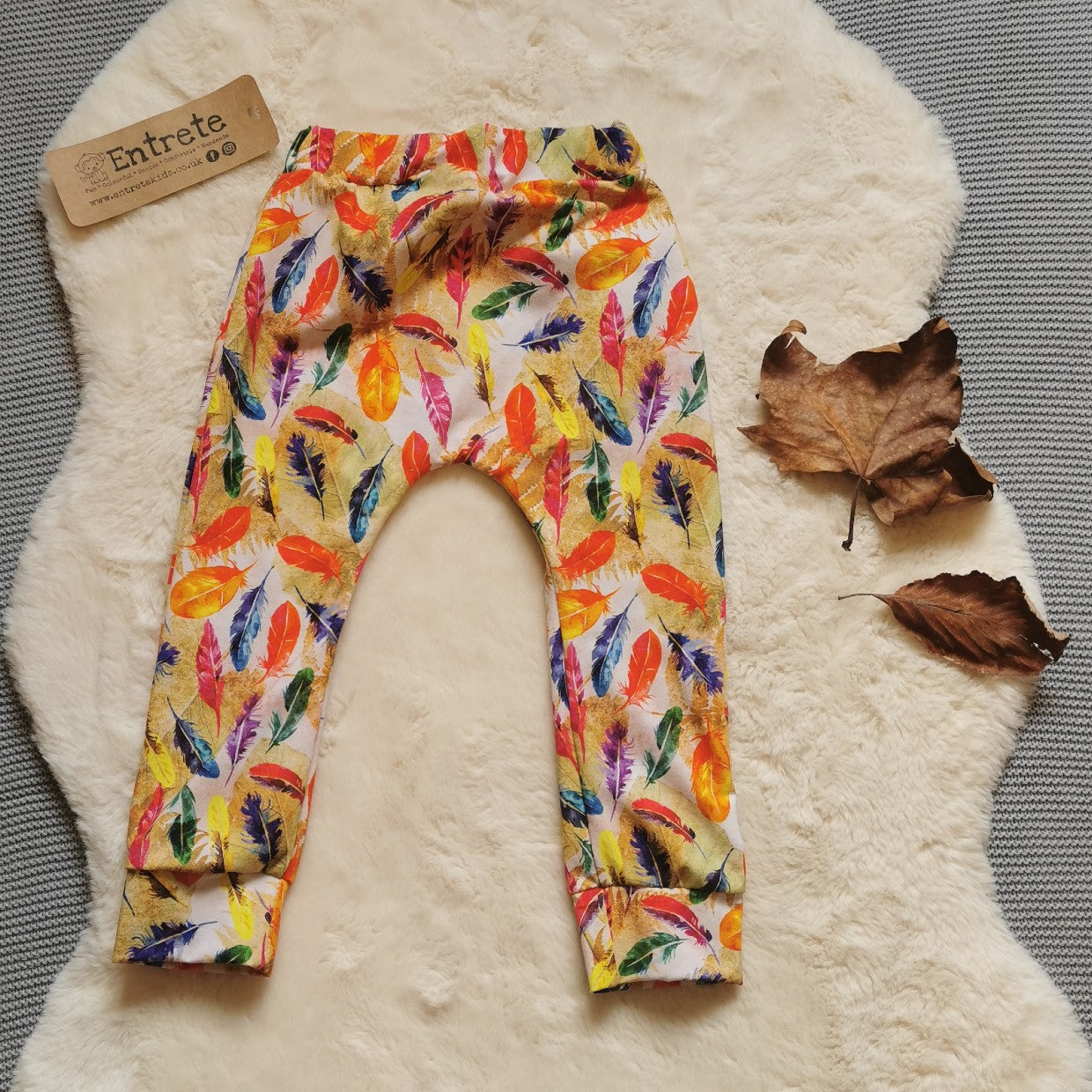 Rear view of harem joggers with elasticated waist, dropped crotch and roll-able ankle cuffs. Handmade in vibrant feathers cotton jersey.