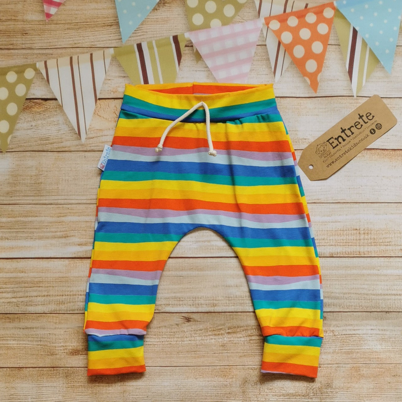 Harem joggers with elasticated waist, dropped crotch and roll-able ankle cuffs. Handmade in colourful red rainbow striped cotton jersey.