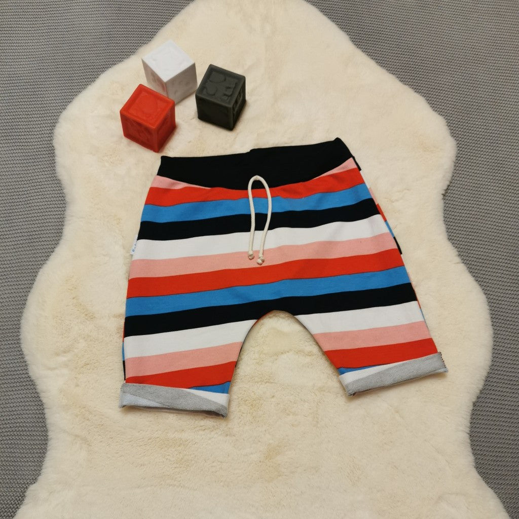 Kids harem shorts, handmade using colour striped cotton French terry and navy ribbing. Featuring elasticated waist, rolled ends and lowered crotch. 