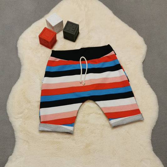 Kids harem shorts, handmade using colour striped cotton French terry and navy ribbing. Featuring elasticated waist, rolled ends and lowered crotch. 