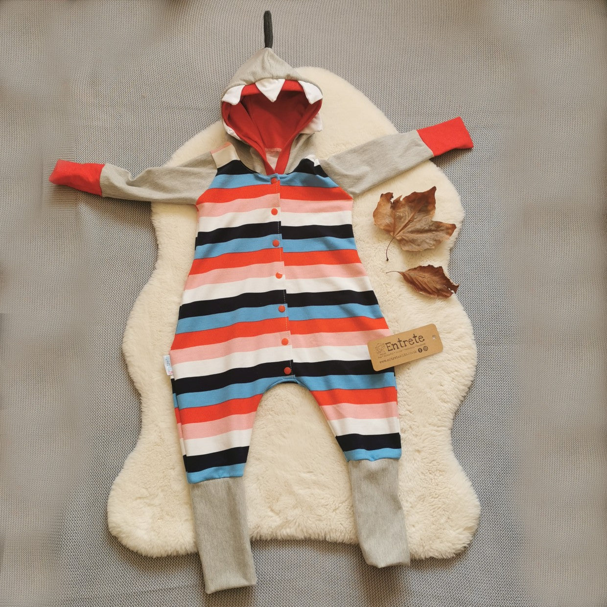 The warm, colourful and fun colour striped shark animal romper. Handmade using colour striped cotton french terry, grey cotton sweat fabric and red cotton jersey.