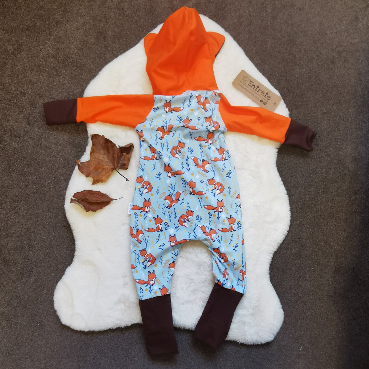 Rear of The adorable hooded fox romper, great for role play. Handmade using sky blue foxes, orange, brown and white cotton jersey's and cream cotton ribbing.