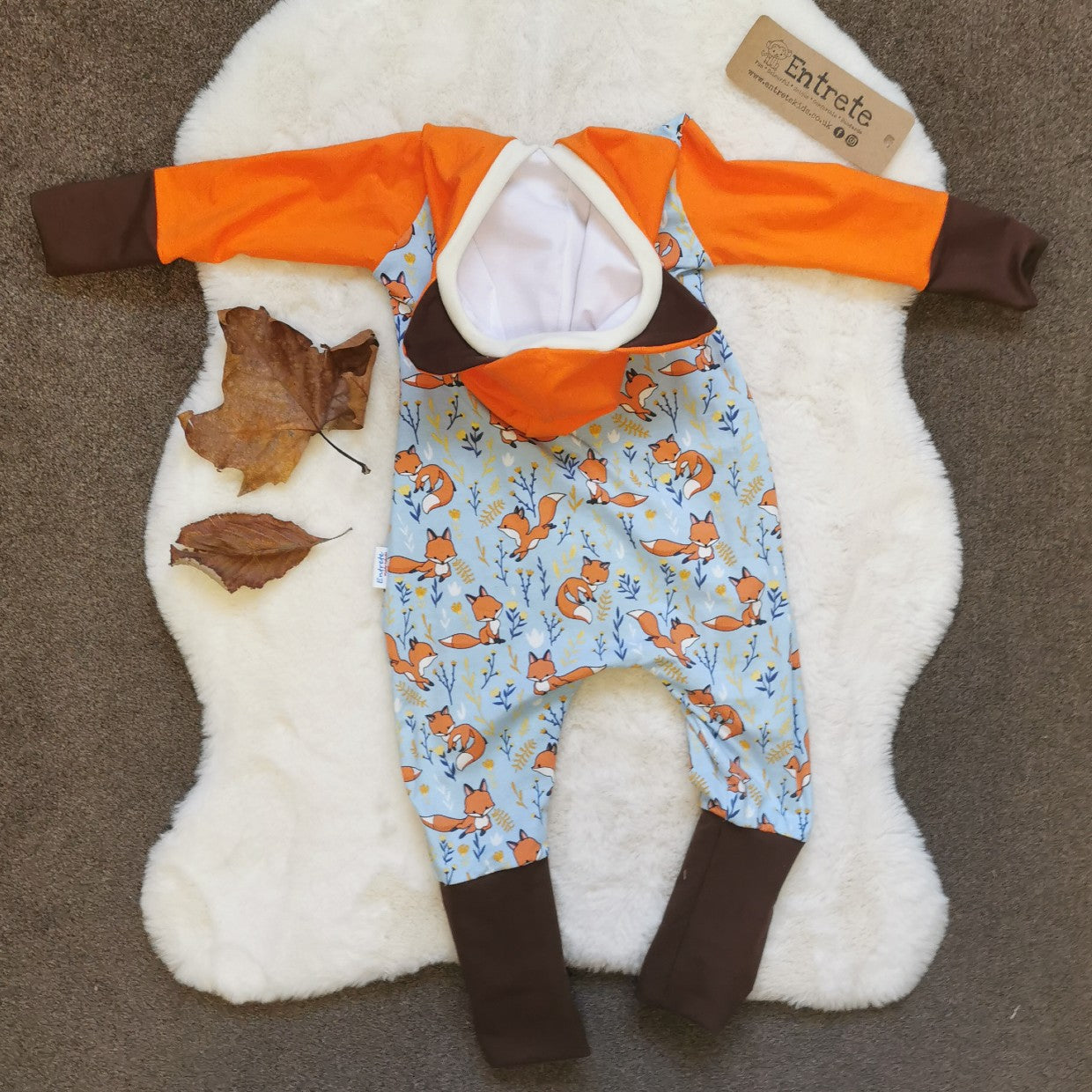 Rear  view of The adorable hooded fox romper, great for role play. Handmade using sky blue foxes, orange, brown and white cotton jersey's and cream cotton ribbing.