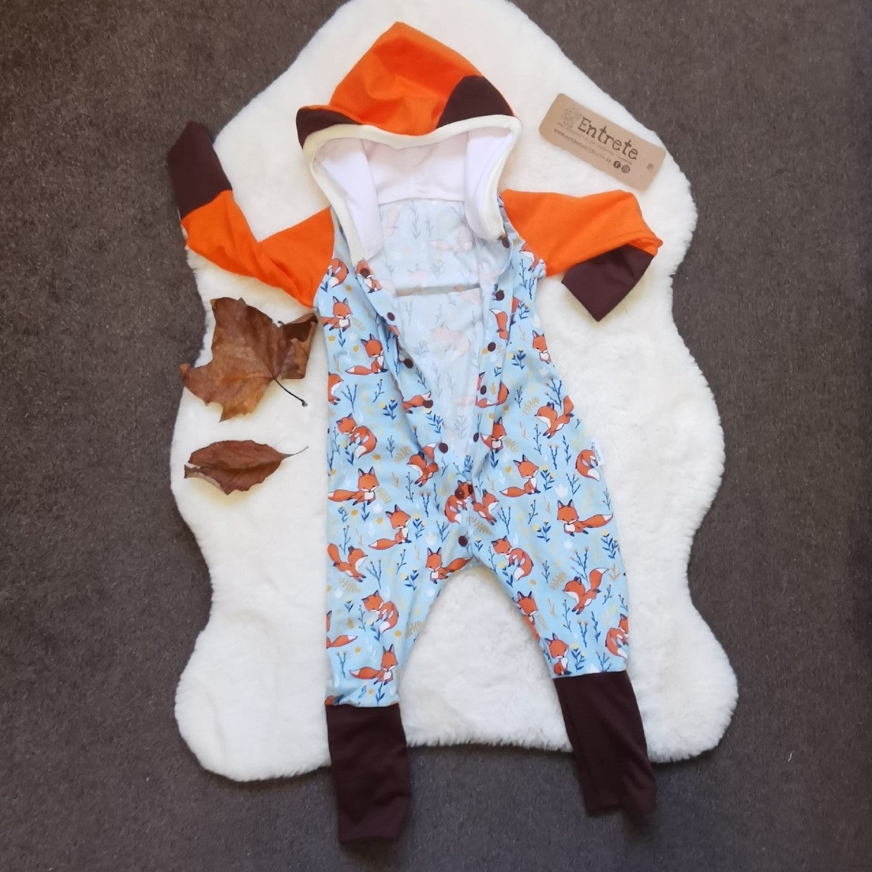 The adorable hooded fox romper, great for role play. Showing the front popper entry open. Handmade using sky blue foxes, orange, brown and white cotton jersey's and cream cotton ribbing.