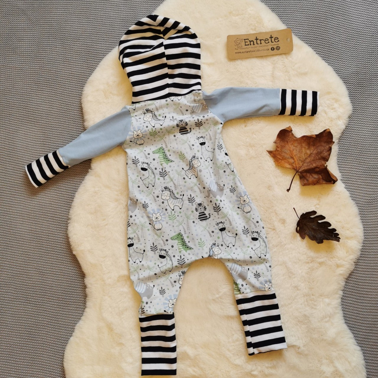 Rear view of the adorable kids animals romper with contrasting monochrome stripes. Handmade using light blue kids animals, baby blue and monochrome striped cotton jerseys'.