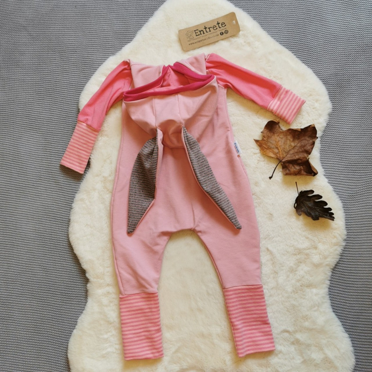 Rear view of Fun pink bunny romper. Handmade using pink cotton sweat fabric, pink cotton jersey, pink striped and fuchsia cotton ribbing and jersey lurex.