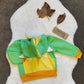 The vibrant and fun green and yellow dinosaur hoodie. Your little dinosaur fanatic won't want to take it off. With the hood folded.
