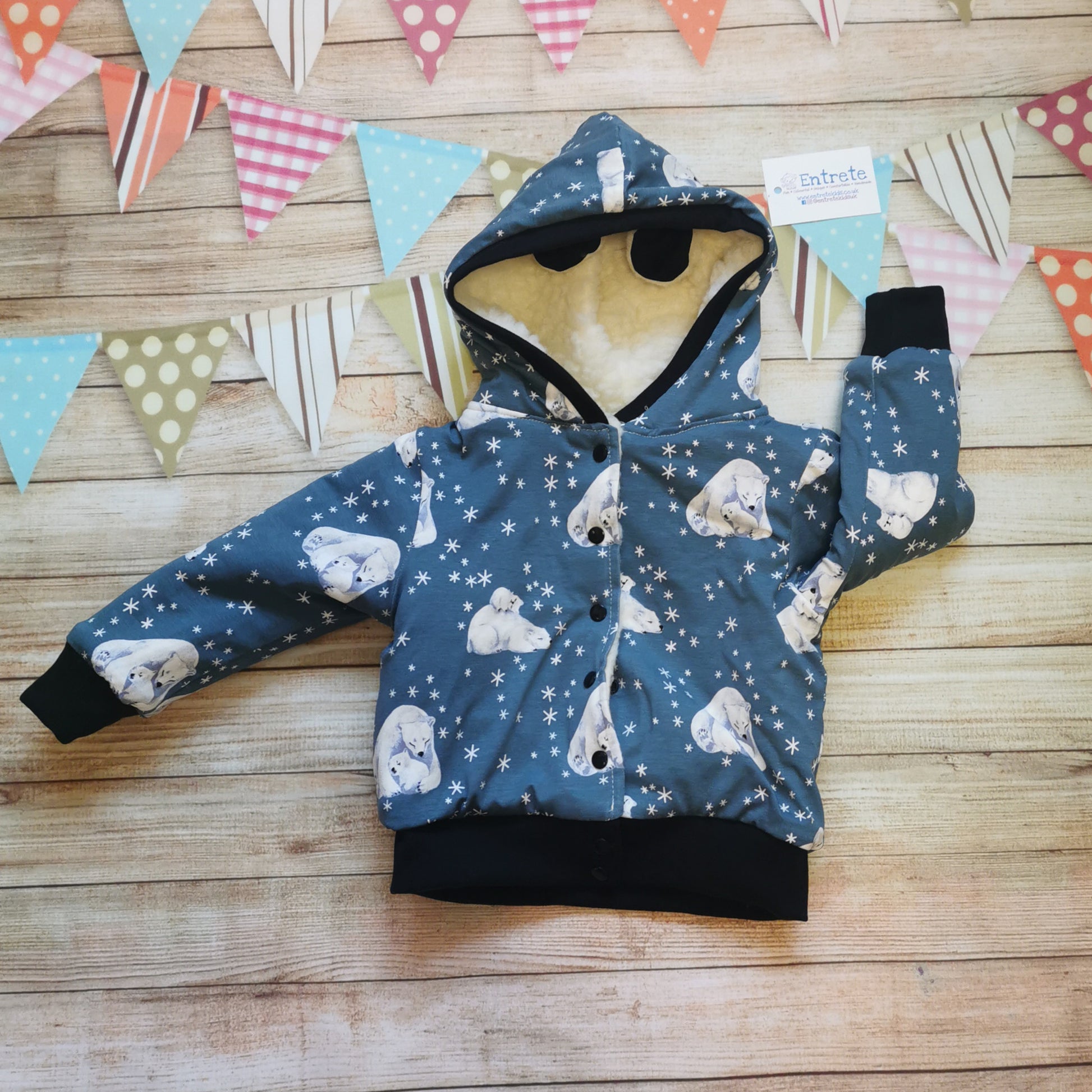 The reverse side of the adorable polar bear hoodie. Handmade using dusty blue polar bears cotton jersey and black cotton ribbing, with warm sherpa fur lining.