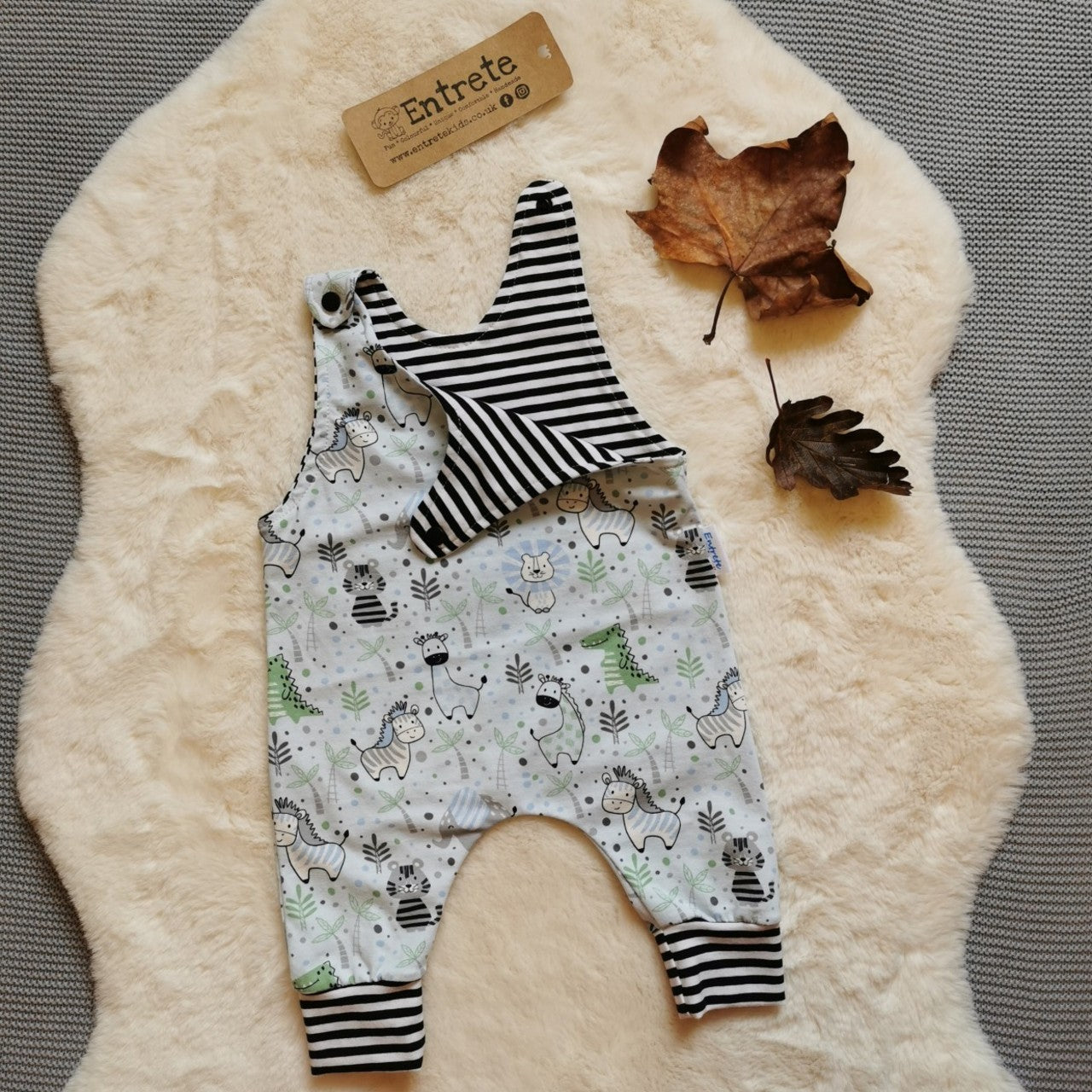 The light blue and striped kids animals romper. Perfect for any animal fanatic! Handmade using light blue kids animals and monochrome striped cotton jerseys'.  Shown with one of the shoulder poppers open.