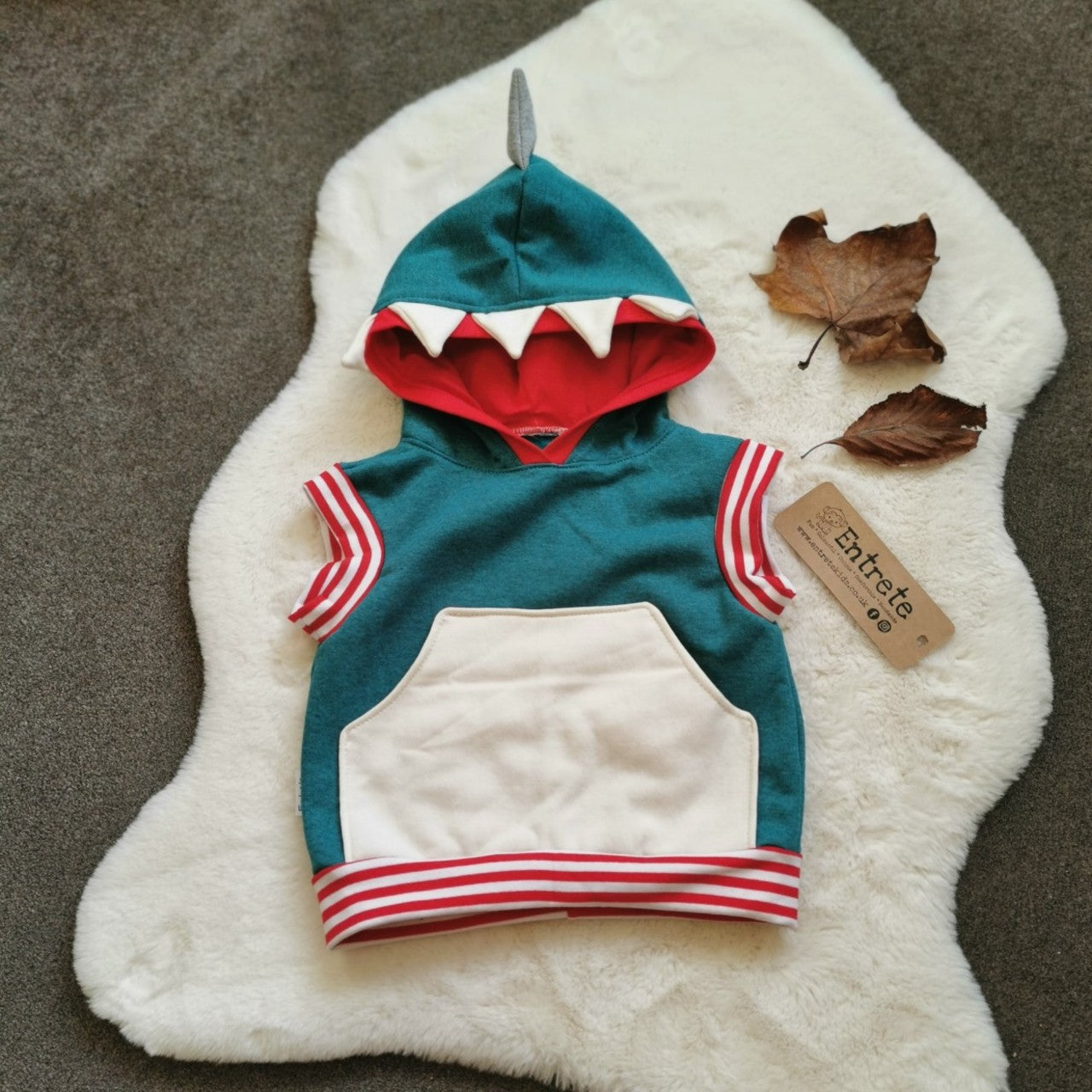 The fearsome teal shark hoodie. With sharks teeth and fin to the hood and a contrasting front pocket. Handmade using teal, white and grey cotton sweatshirt fleeces, red cotton jersey and red striped cotton ribbing.